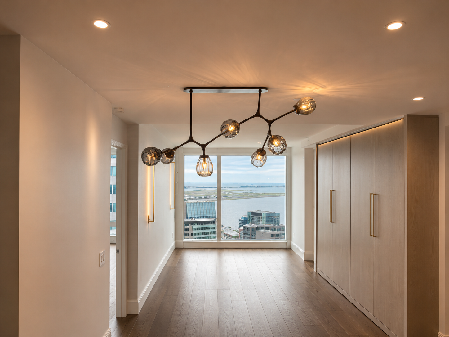 Branching chandelier with smoked glass pendants in high-floor luxury Boston residence overlooking the harbor by Luster and Volt
